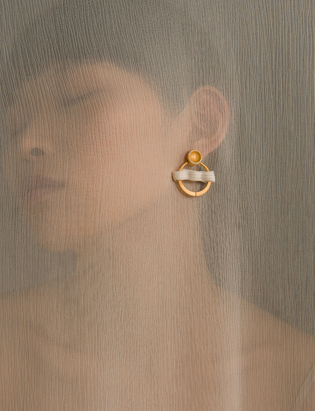 Photo of woman wearing earring.