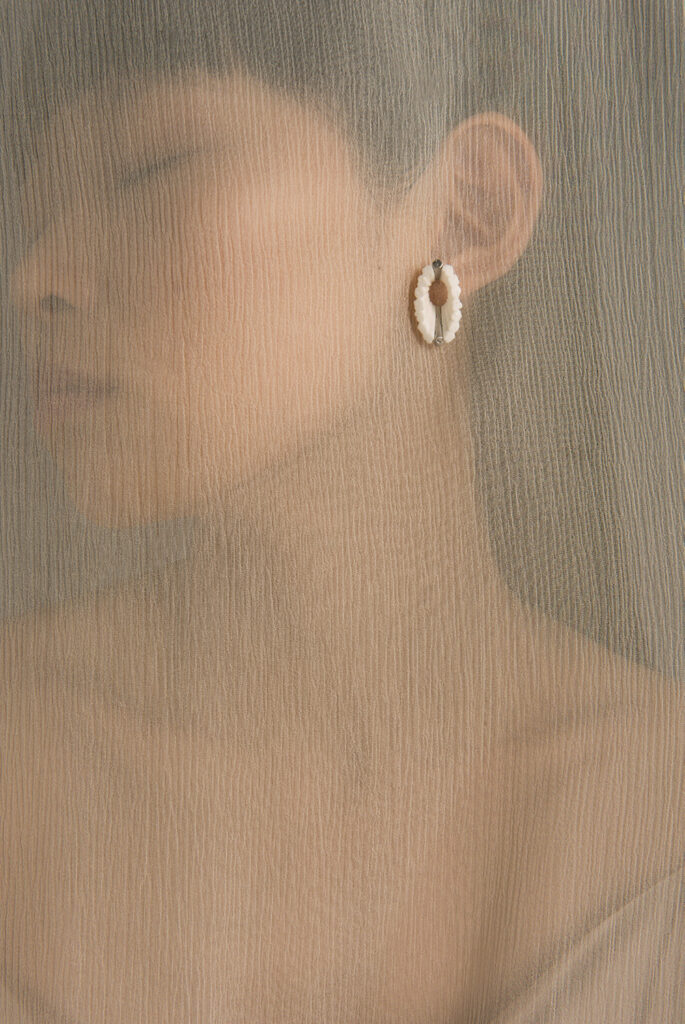 Photo of woman wearing earring.
