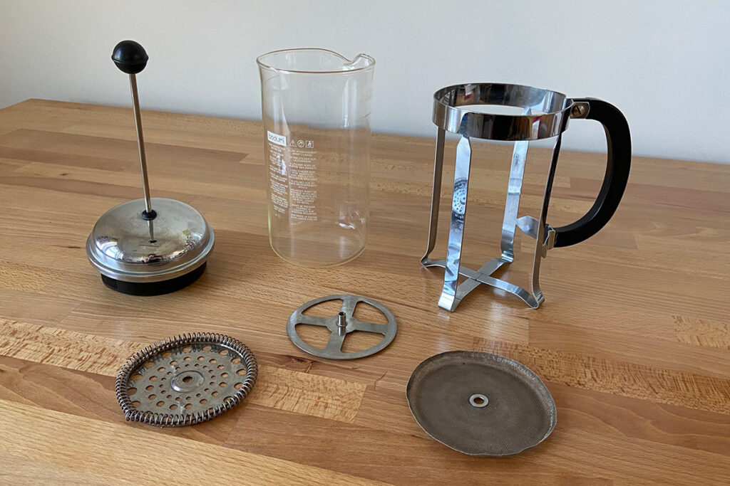 A dissasembled french press coffee maker