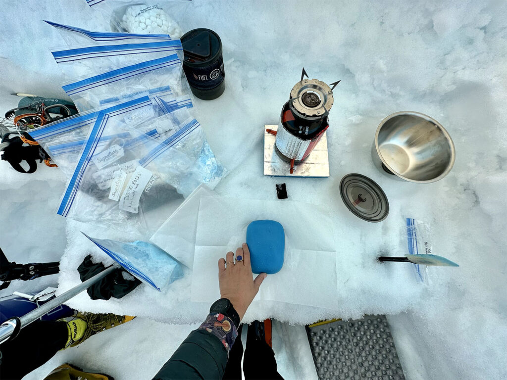 An overhead shot of cooking gear outdoors in the snow.