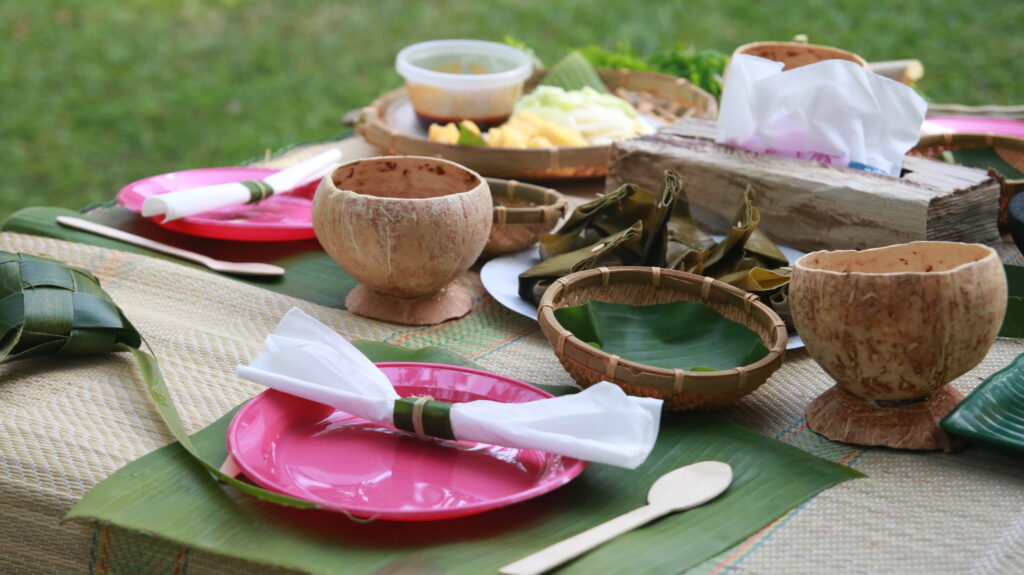 A table set with banana leaves and dishes.